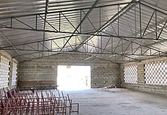 The brick windows and the metal roof are installed