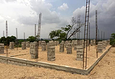 Once sand is poured over the stones, wall construction can begin