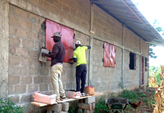 Metal shutters are painted and installed