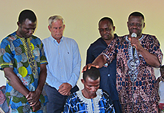 Sato's mentors  address the crowd and pray over Sato