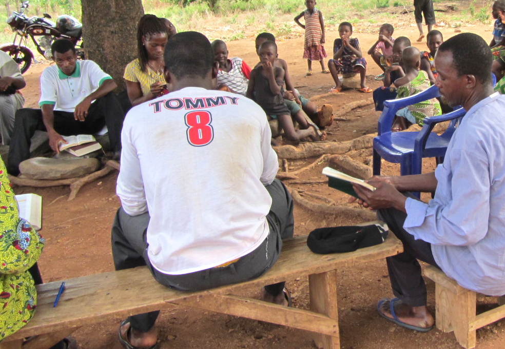 Villagers Using New Testaments