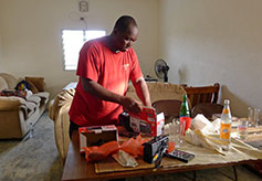 Pastor Moussa Testing SD Card in Solar-Powered Radio