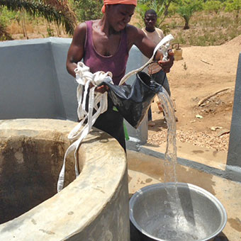 Woman Drawing Water from the New Well